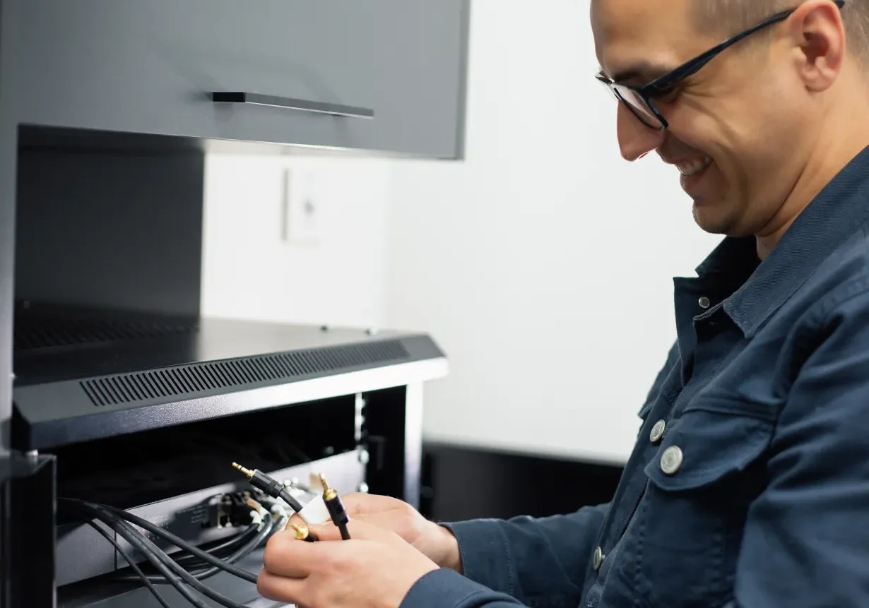 Man connecting cables in a server rack.