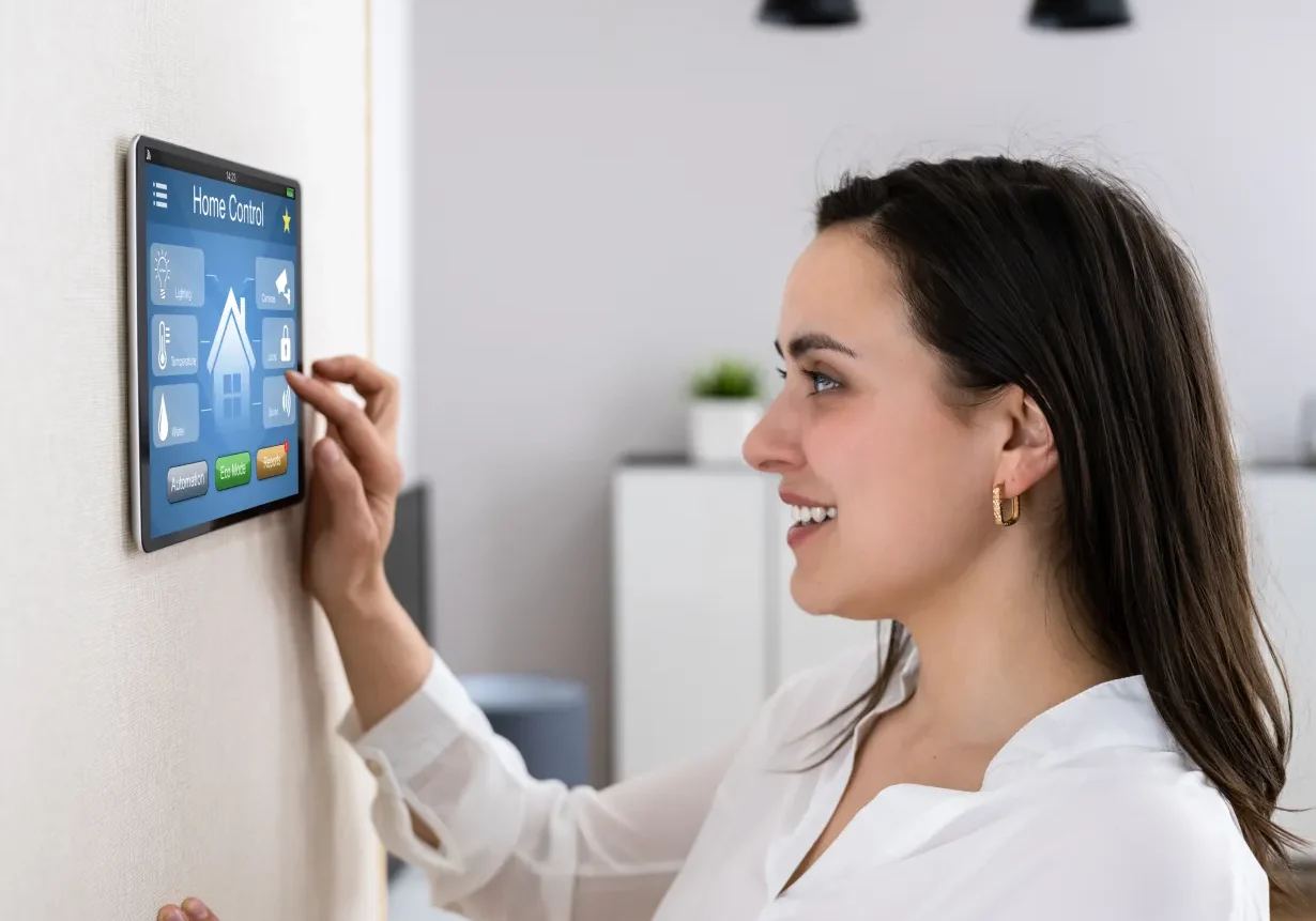 Woman using smart home control panel.